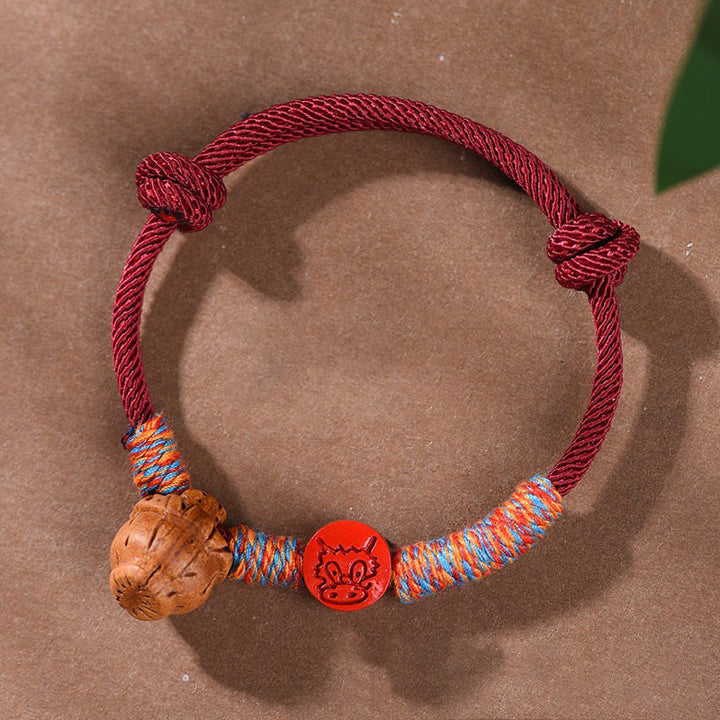 Buddha Stonesハンドメイドの十二支の赤紐の辰砂の幸運ブレスレット