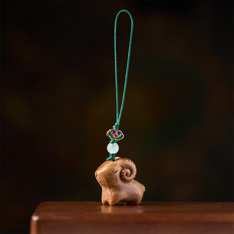 Buddha Stones 手彫りの白檀製ヤギのポジティブキーホルダー - image 1