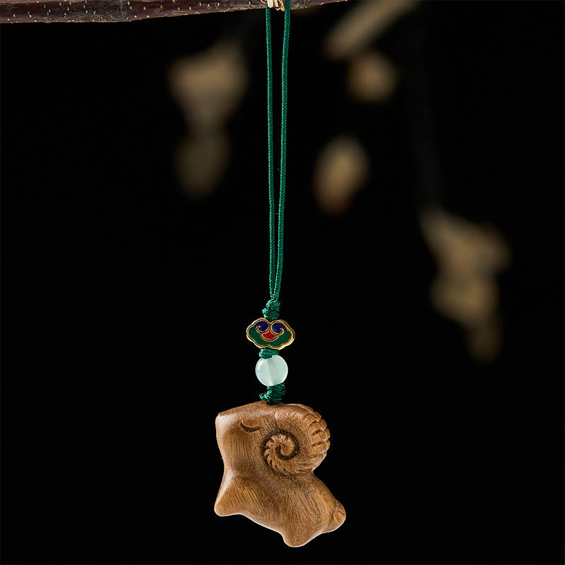 Buddha Stones 手彫りの白檀製ヤギのポジティブキーホルダー - image 2