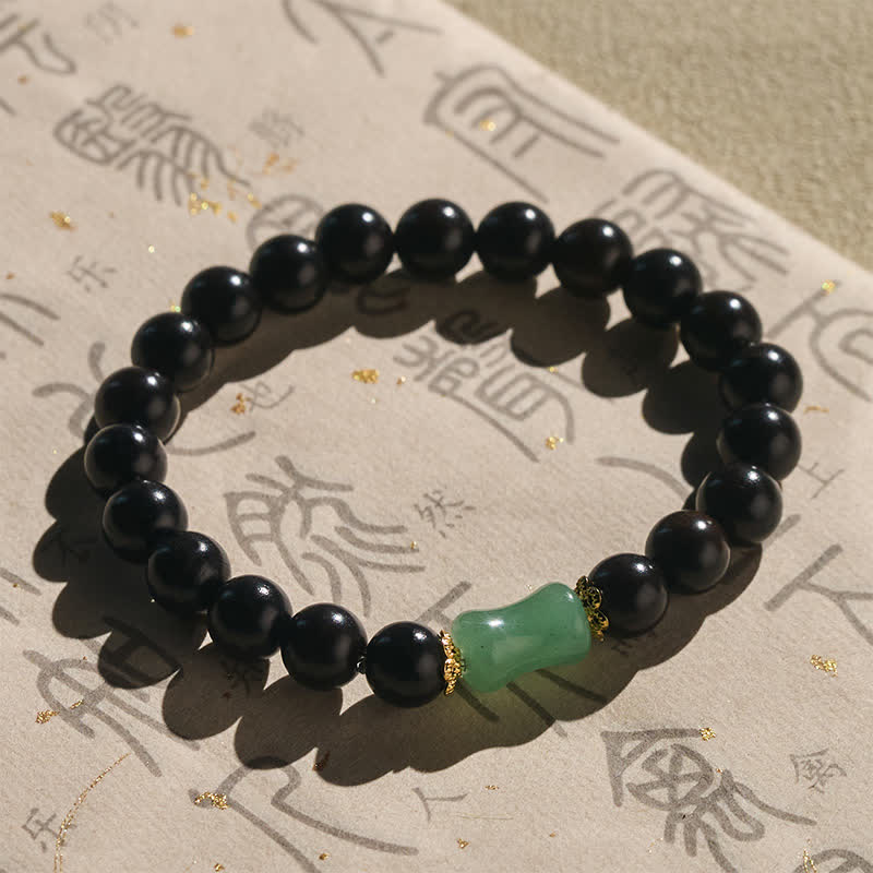 Buddha Stones 黒檀と緑檀の天然木目が特徴のユニセックスブレスレット - image 1