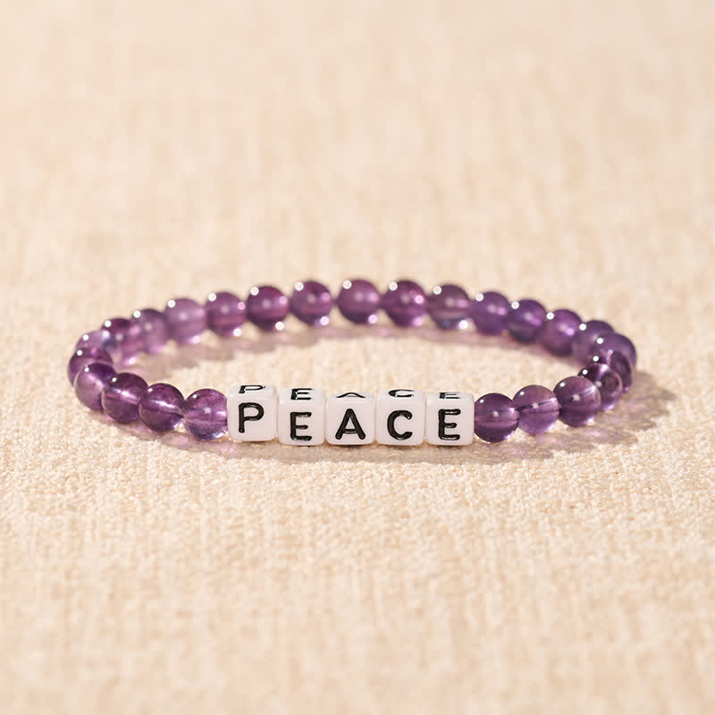 Buddha Stones アメジストの「PEACE」文字ビーズ入り瞑想ブレスレット - image 1